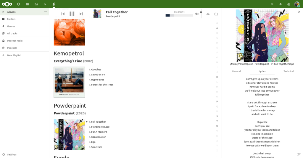 Screenshot of the Nextcloud Music app as seen through a desktop web browser. There are several album covers visible, and one of the tracks is playing with the lyrics visible and a playing interface with controls etc too.